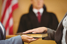 Witness swearing on the Bible telling the truth in the court room