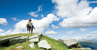 Mother and son hiking in a mountain landscape.