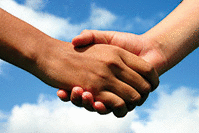 A handshake between an indian lady and white boy symbolizes friendship across gaps of race, age and gender.