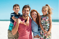 Smiling family with two children enjoying vacation at beach!