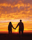 A young couple in love admiring the sunset and nature.