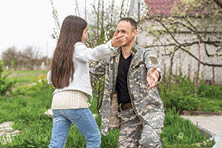 A tearful picture of a couple greeting each other.