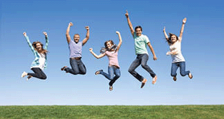 A group of young people jumping outdoors.