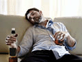 drunk business man at home lying asleep on couch sleeping