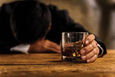 A man holding a glass off whiskey.