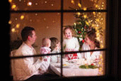 A happy family sitting around a decorated table for the holiday.